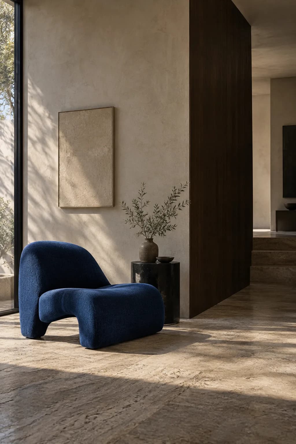 Sculptural blue chair in a warm stone interior